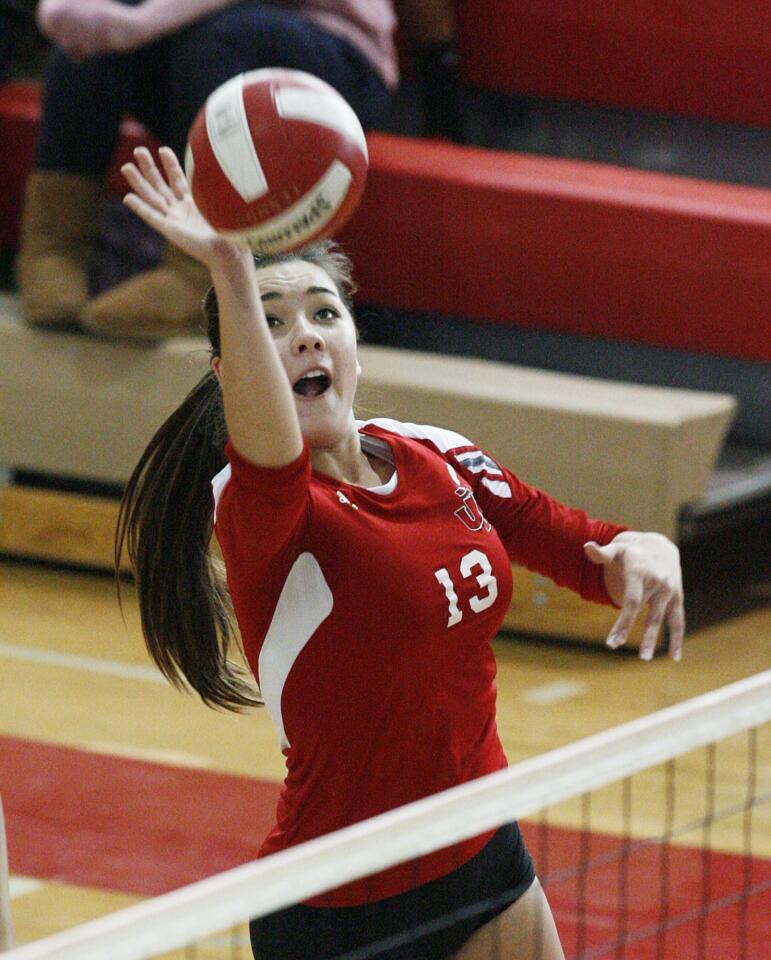 Burroughs' Caitlin Cottrell tips the ball in a Pacific League girls volleyball match against Arcadia at Burroughs High School in Burbank on Tuesday, October 23, 2012.