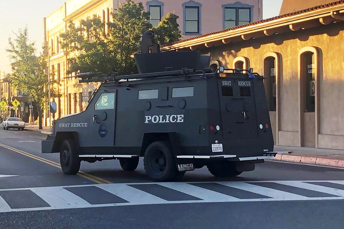 An armored vehicle patrols the streets of Paso Robles after a sheriff's deputy was wounded by a gunman.