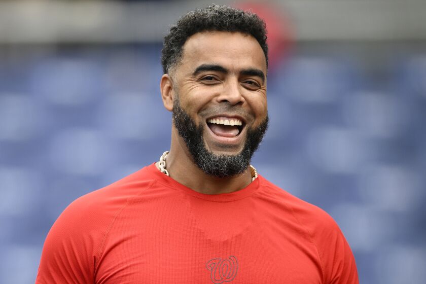 Washington Nationals' Nelson Cruz laughs during batting practice before a baseball game against the Houston Astros, Friday, May 13, 2022, in Washington. (AP Photo/Nick Wass)
