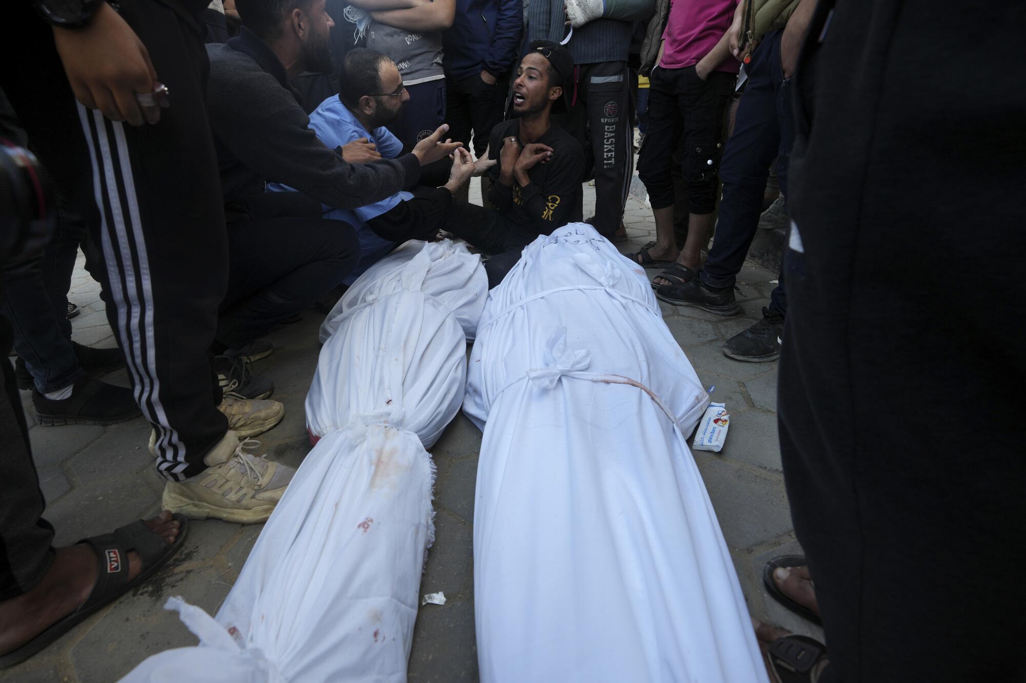 Two enshrouded bodies of Palestinians killed in the Israeli bombing of Gaza