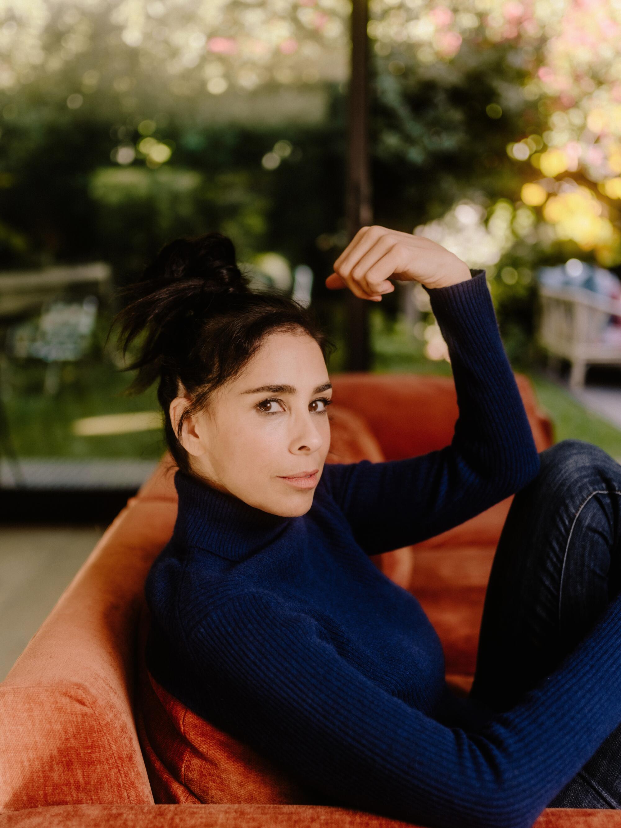 Sarah Silverman reclines on a couch