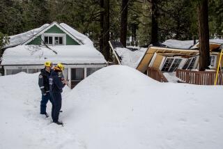 CRESTLINE, CA - MARCH 6, 2023: Fire crews document the damage of a house with a collapsed roof on March 6, 2023 in Crestline, California. Recent storms dropped more than 100 inches of snow in the San Bernardino Mountains stranding many residents (Gina Ferazzi / Los Angeles Times)
