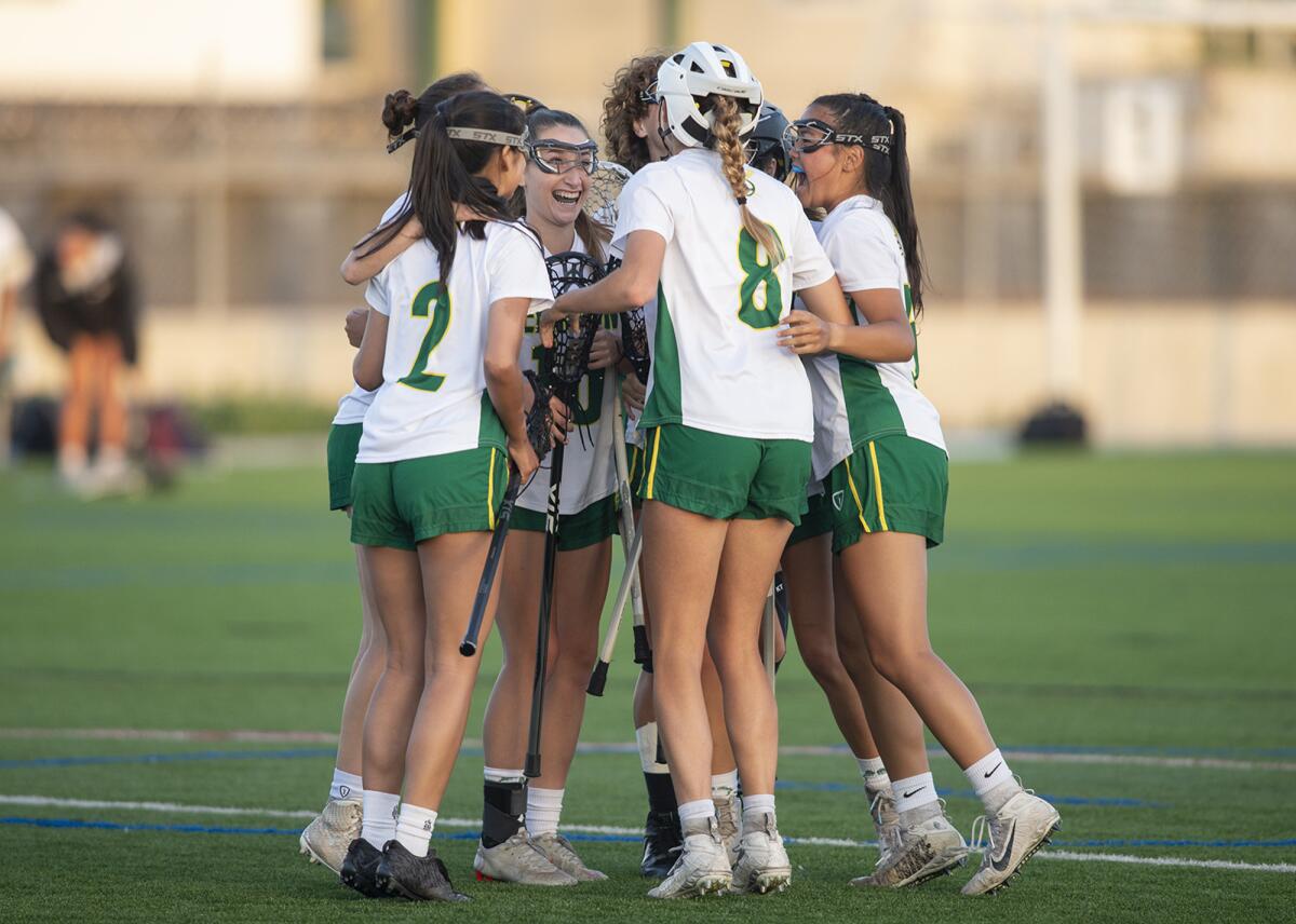 Edison's girls' lacrosse team celebrates a goal during a Sunset League match against Corona del Mar on Tuesday.