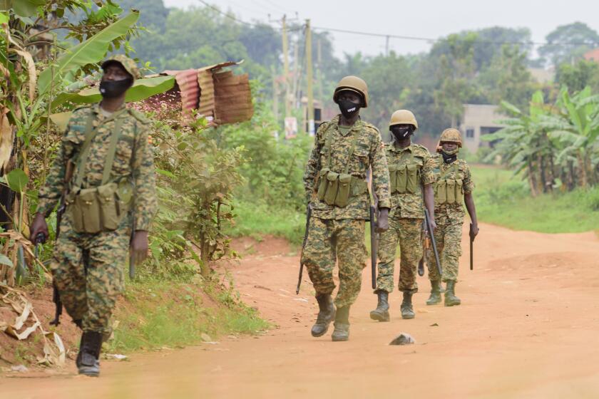 Ugandan soldiers outside the home of opposition challenger Bobi Wine in Kampala on Saturday. 
