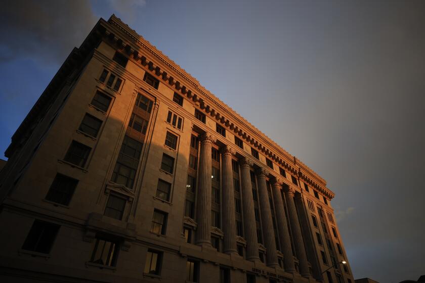 FILE - The sun sets on the Fulton County Courthouse, Monday, Aug. 14, 2023, in Atlanta. A bail bondsman charged alongside former President Donald Trump and 17 others has become the first defendant in the Georgia election interference case to accept a plea deal with prosecutors. Scott Hall pleaded guilty in court on Friday, Sept. 29, to five counts of conspiracy to commit intentional interference with performance of election duties, all misdemeanors. Prosecutors had accused him of participating in a breach of election equipment in rural Coffee County. (AP Photo/Alex Slitz, File)