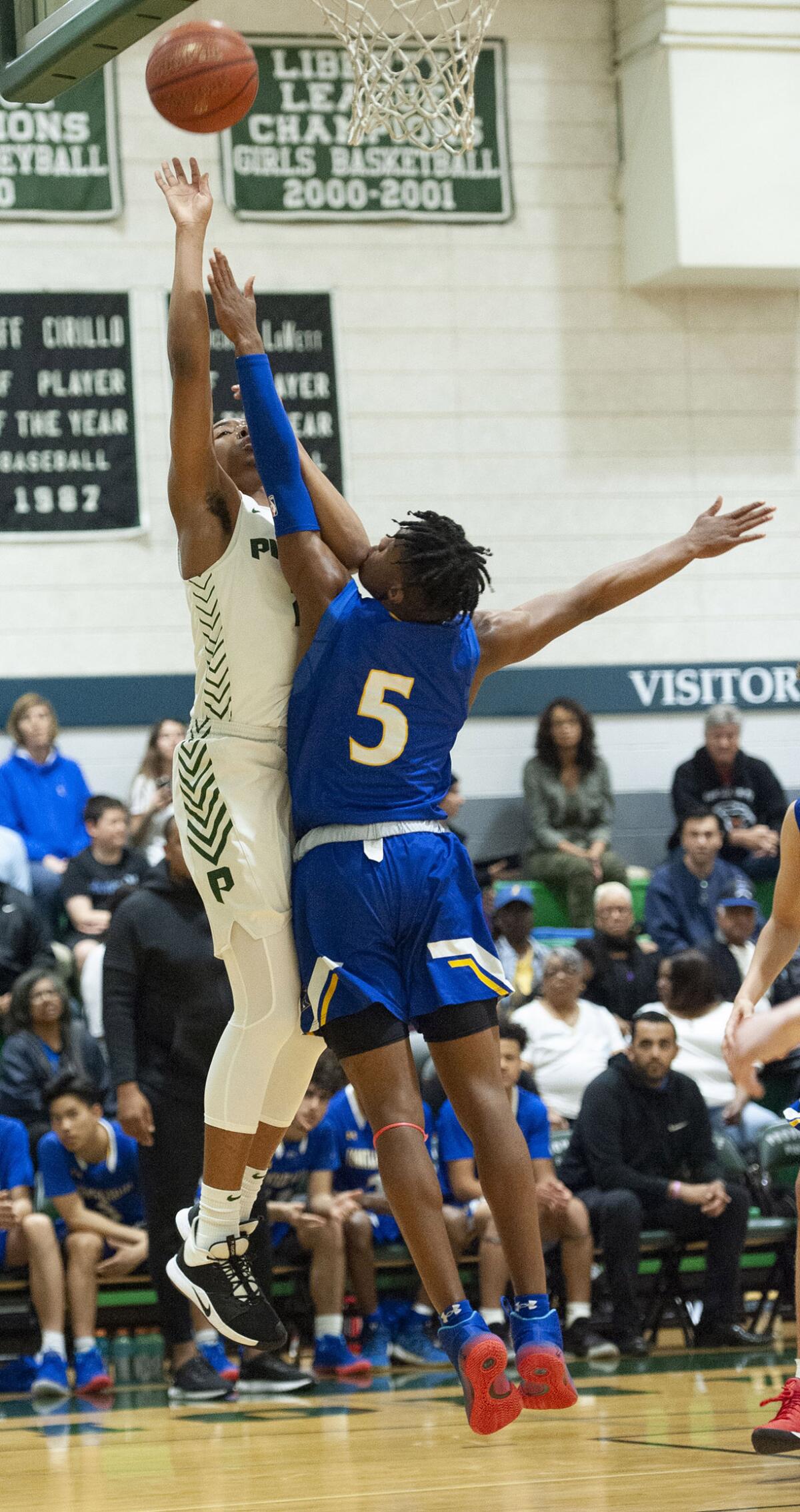 Providence's A'Jahni Levias puts the ball up over Fountain Valley's Jermiah Davis during CIF State Division III Southern California Regional semifinal at Providence High. (Photo by Miguel Vasconcellos)