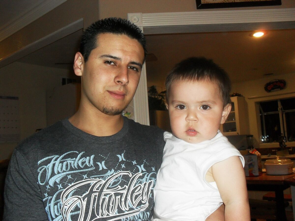 Jacob Wallis, photographed in 2010, with his toddler son, Izaiah, just months before Izaiah was struck by a teenage drunk driver and left severely disabled.  