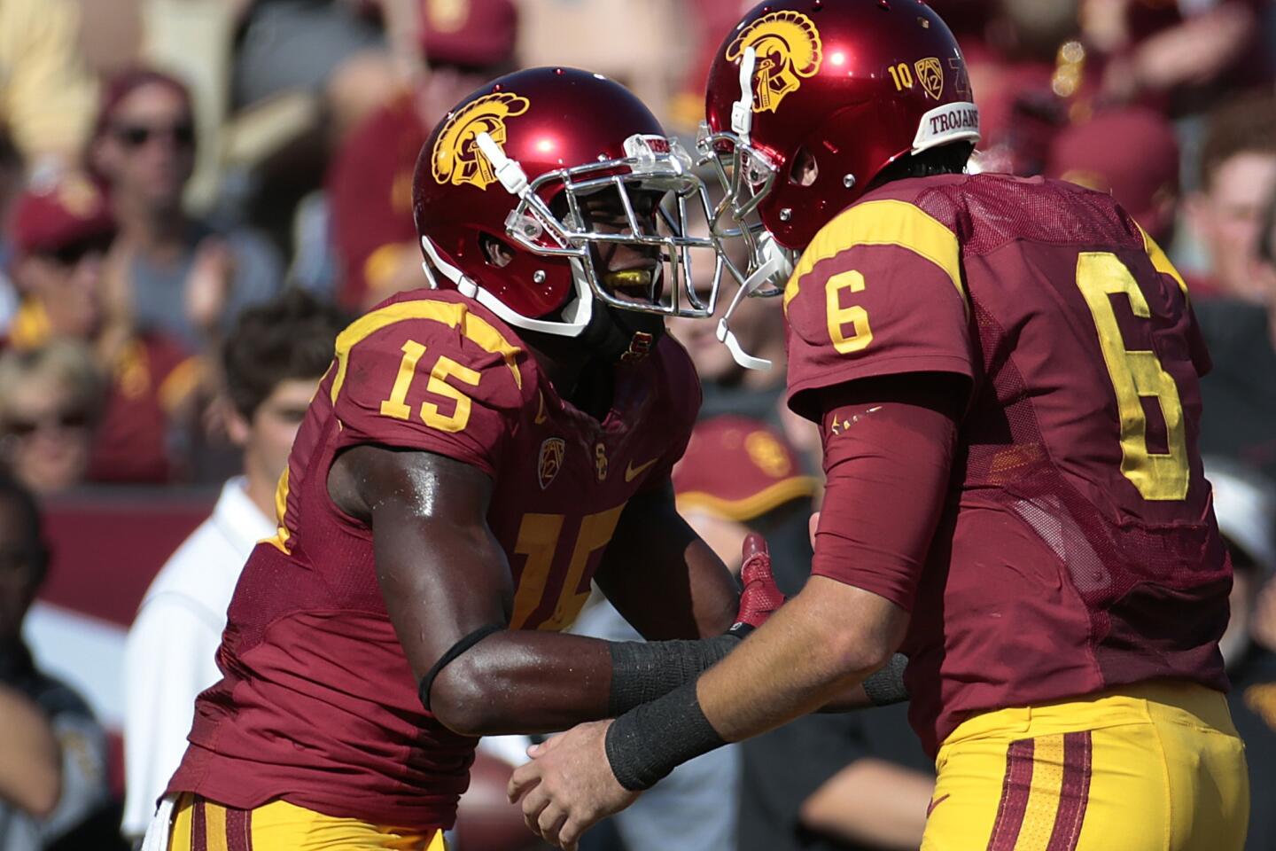 USC receiver Nelson Agholor celebrates with quarterback Cody Kessler after one of his three touchdown catches Saturday against Colorado.