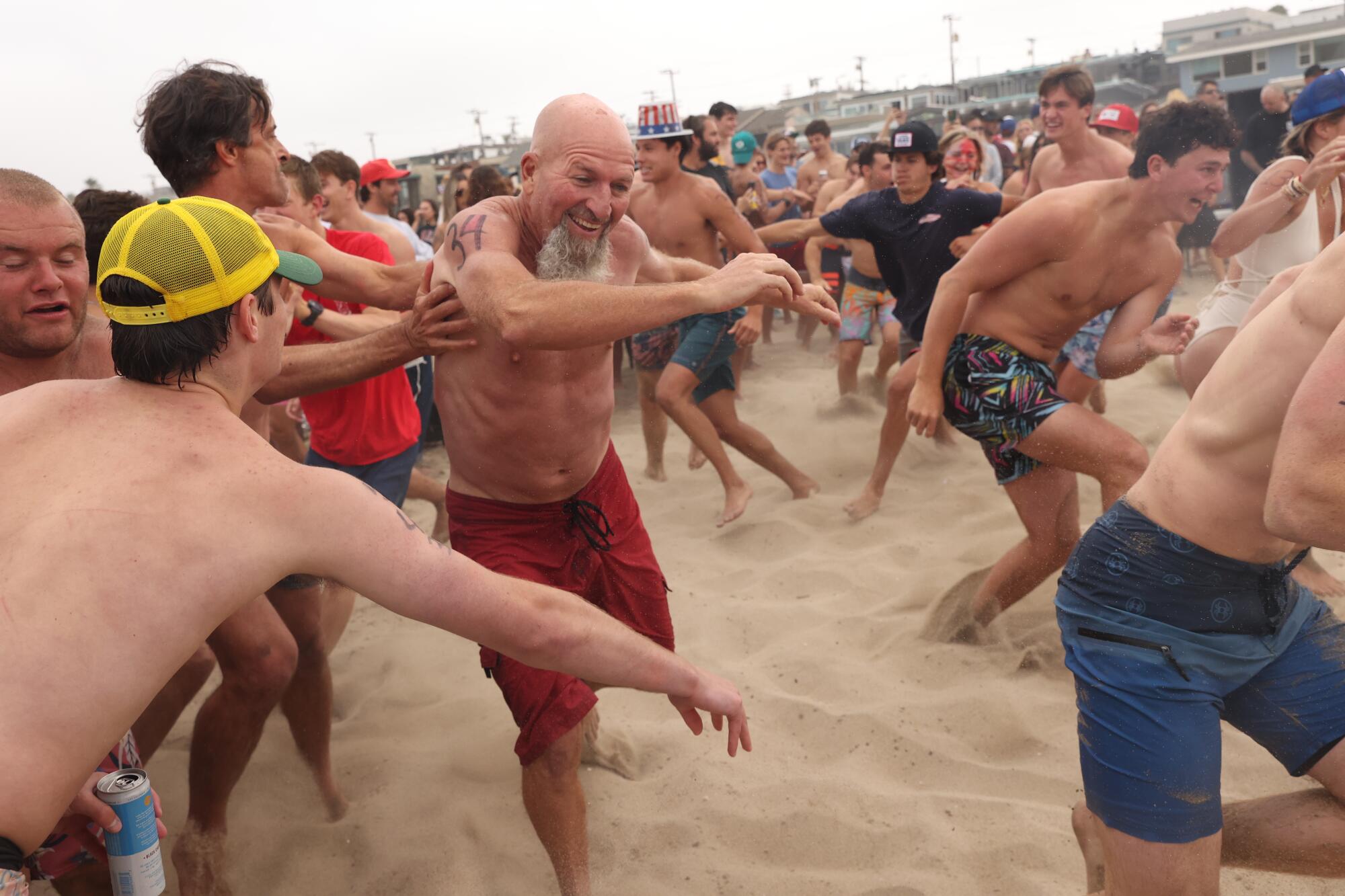 Participants keep loose in a mosh pit during the Hermosa Beach Ironman on July 4.