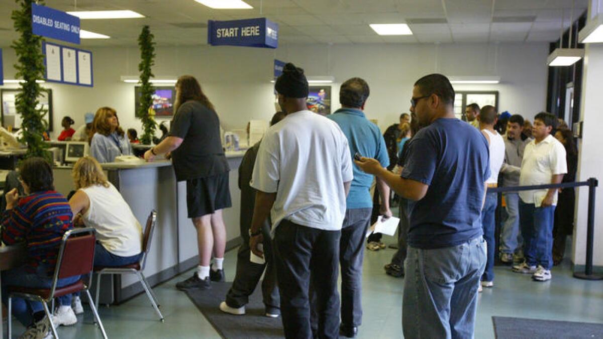 A DMV office in Palmdale with lines of people waiting for services.
