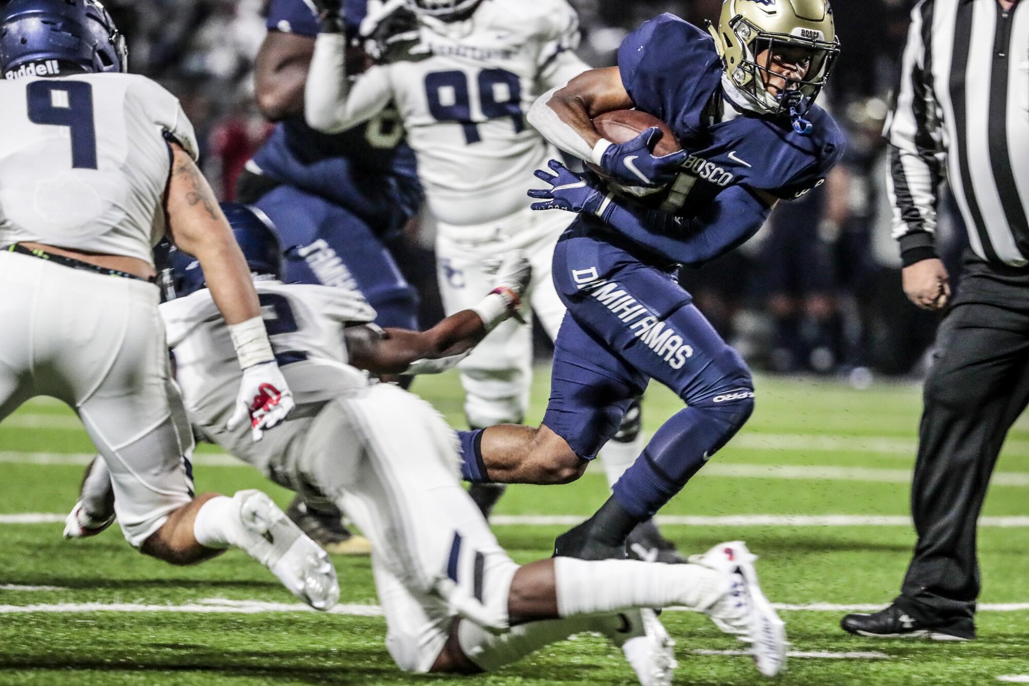 St. John Bosco running back Rayshon Luke breaks through the line for a touchdown run.