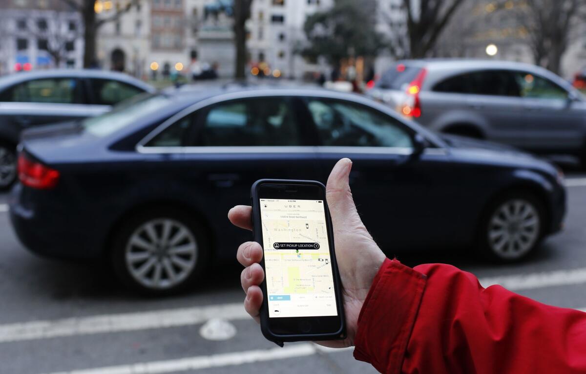 A Uber user hails a ride in Washington, D.C., in 2015.