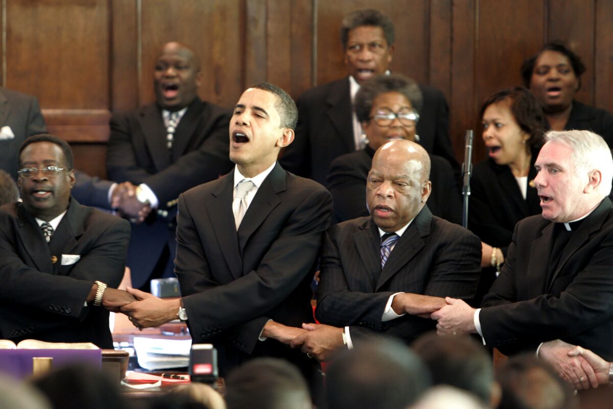 FILE - In this Sunday March 4, 2007, file photo, from left, Brown Chapel AME Church Pastor James Jackson, Democratic presidential candidate Sen. Barack Obama, D-Ill., U.S. Rep. John Lewis, D-Georgia, and Rev. Clete Kiley, hold hands and sing at the end of a church service in Selma, Ala., on the commemoration of the Rev. Martin Luther King Jr. protest march from Selma to Montgomery, Ala. Lewis, who carried the struggle against racial discrimination from Southern battlegrounds of the 1960s to the halls of Congress, died Friday, July 17, 2020. (AP Photo/Rob Carr, File)