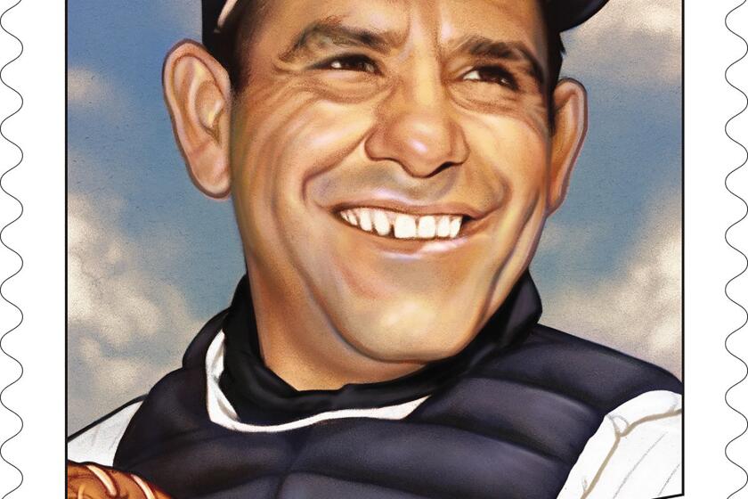 This handout provided by the United States Postal Service shows the Yogi Berra stamp, issued on Thursday, June 24, 2021. “We hope this stamp will serve as a reminder of Yogi’s larger than life personality — both on and off the field,” said Ron A. Bloom, chairman, U.S. Postal Service Board of Governors.(United States Postal Service via AP)