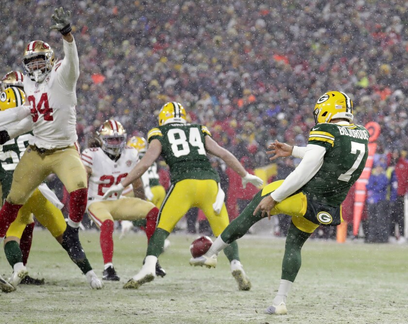 CORRECTS TO 49ERS' JORDAN WILLIS NOT ALEX BARRETT - San Francisco 49ers defensive end Jordan Willis (94) blocks a punt by Green Bay Packers punter Corey Bojorquez (7) late in the fourth quarter of an NFC divisional playoff NFL football game Saturday, Jan. 22, 2022, in Green Bay, Wis. 49ers' Talanoa Hufanga (29) ran the ball in for a touchdown. (Dan Powers/The Post-Crescent via AP)