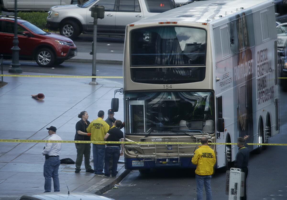 Las Vegas police investigate the scene of a shooting on a bus on Las Vegas Boulevard (John Locher / Associated Press)