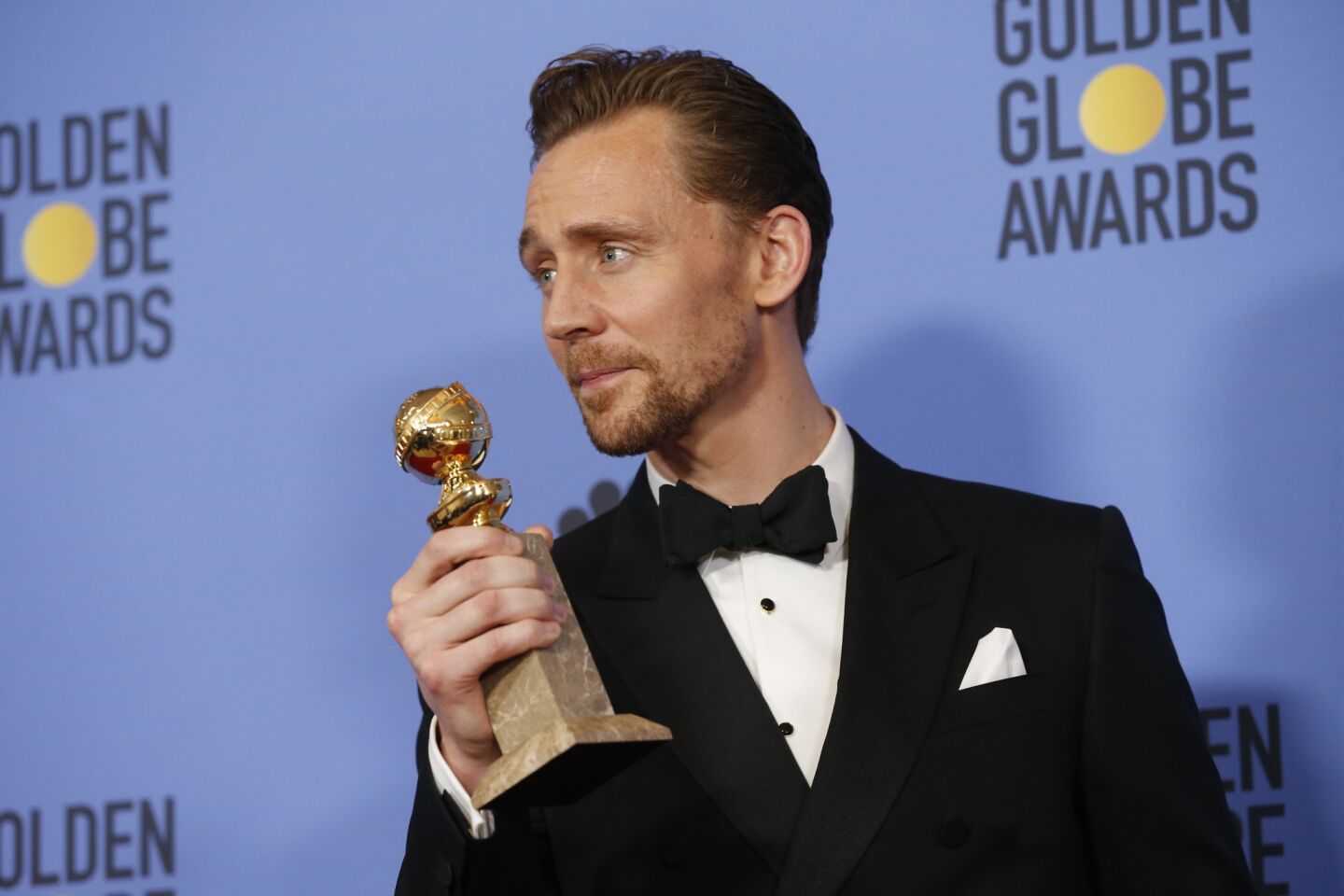 Tom Hiddleston with his award for actor in a TV movie or limited series for "The Night Manager."