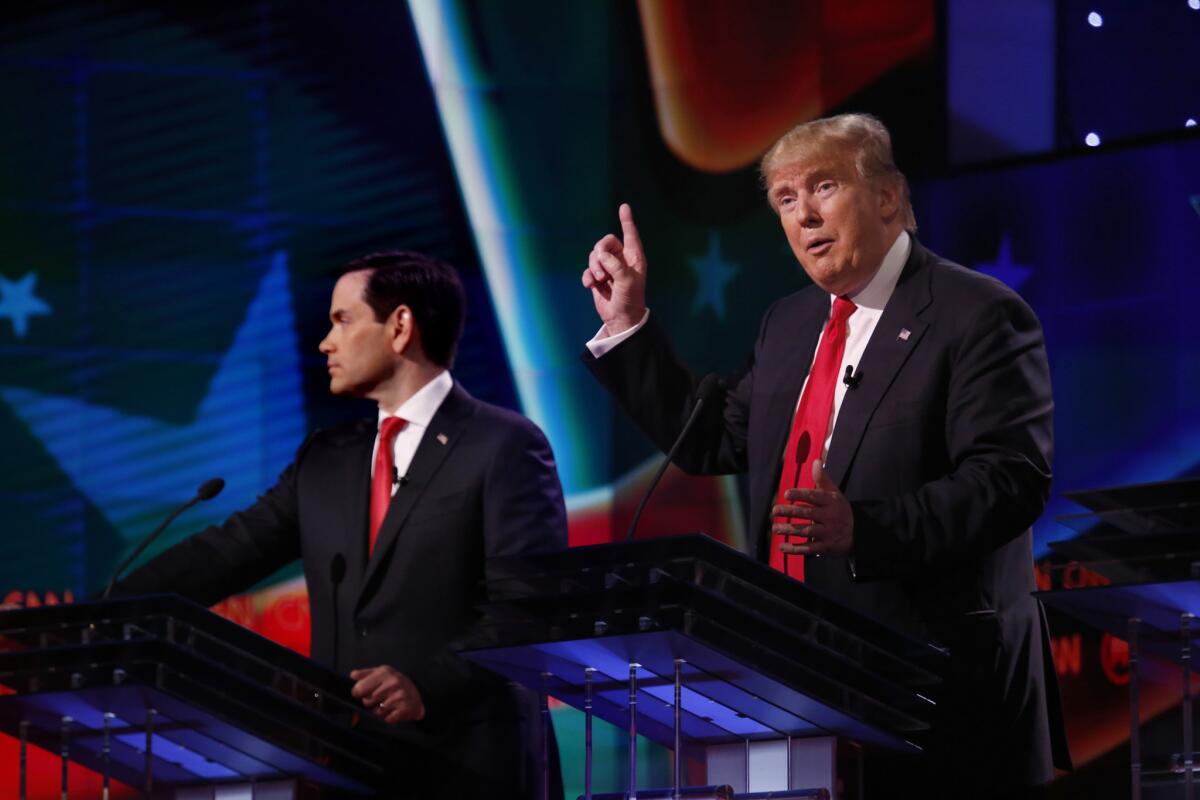 Sen. Marco Rubio, left, and Donald Trump take part in the debate at the University of Miami.