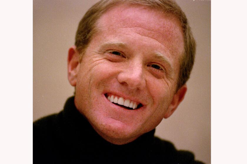 FILE - James Redford, son of actor Robert Redford, laughs during a press conference on Nov. 18, 1998. Redford, a filmmaker, activist, and son of actor Robert Redford, has died. He was 58. Robert Redford’s publicist, Cindi Berger, said in a statement Monday, Oct. 19, 2020, that the 84-year-old father is mourning with his family during this “difficult time.” (AP Photo/Dave Weaver, File)