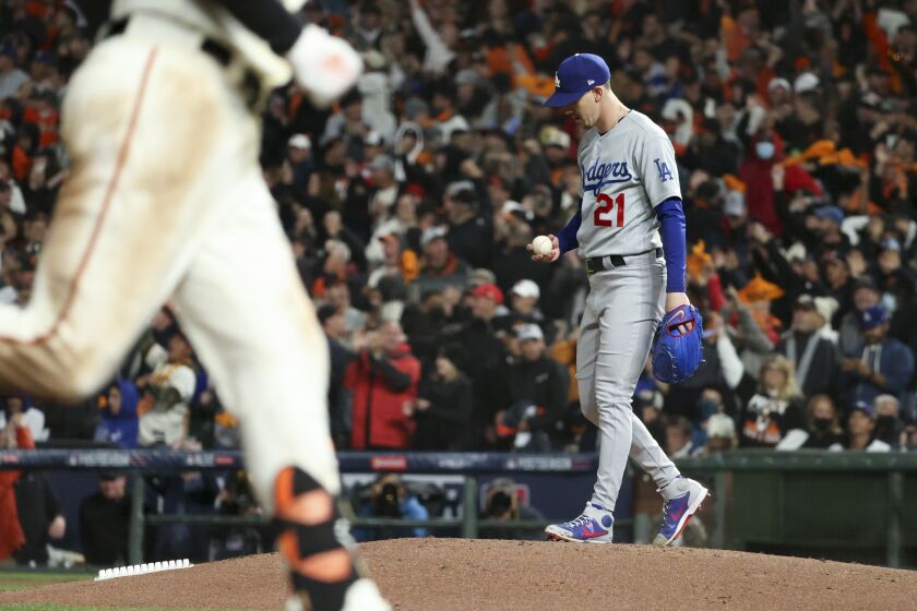 Dodgers starter Walker Buehler reacts after giving up a homer to the Giants' Kris Bryant in the seventh inning Oct. 8, 2021.