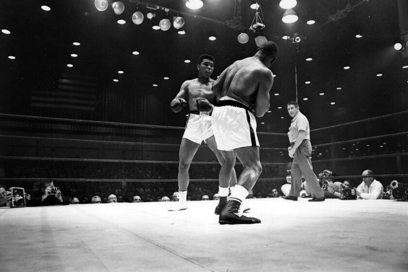 American boxer Cassius Clay (now Muhammad Ali), on his way to defeating Sonny Liston during their world heavyweight title fight at Miami Beach, Fla. on Feb. 25, 1964.