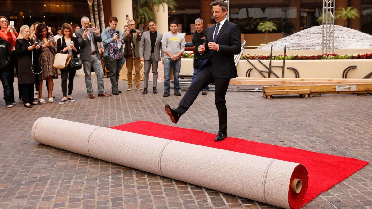 Seth Meyers kicks out the red carpet for the Golden Globes preview day at the Beverly Hilton on Thursday.