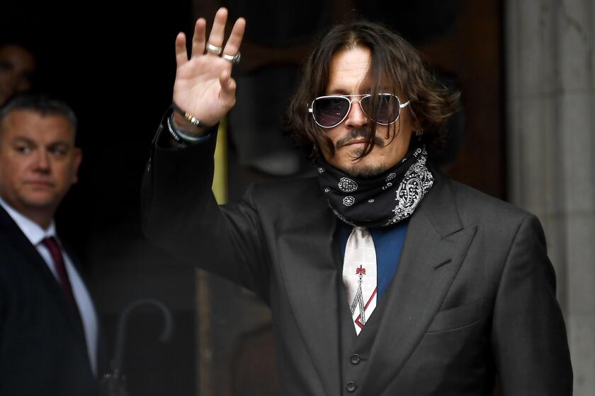 Johnny Depp arrives at the High Court in London, Wednesday July 8, 2020. Johnny Depp is facing a second day of cross-examination by lawyers for British tabloid The Sun, which is defending a libel claim after calling the Hollywood star a “wife beater.” Depp is suing The Sun’s publisher, News Group Newspapers, and its executive editor, Dan Wootton, over an April 2018 article that said he’d been abusive to ex-wife Amber Heard. (AP Photo/Alberto Pezzali)