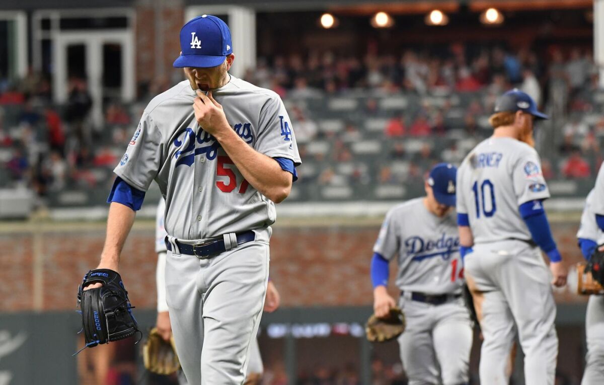 Dodgers reliever Alex Wood comes out of the game after giving up the go-ahead run to the Atlanta Braves in the sixth inning on Sunday.