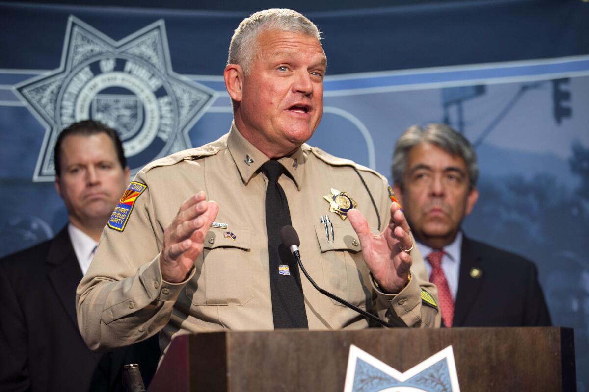 Col. Frank Milstead, director of the Arizona Department of Public Safety, speaks during a news conference Friday night in Phoenix to announce the arrest of a suspect in the Phoenix freeway shootings.