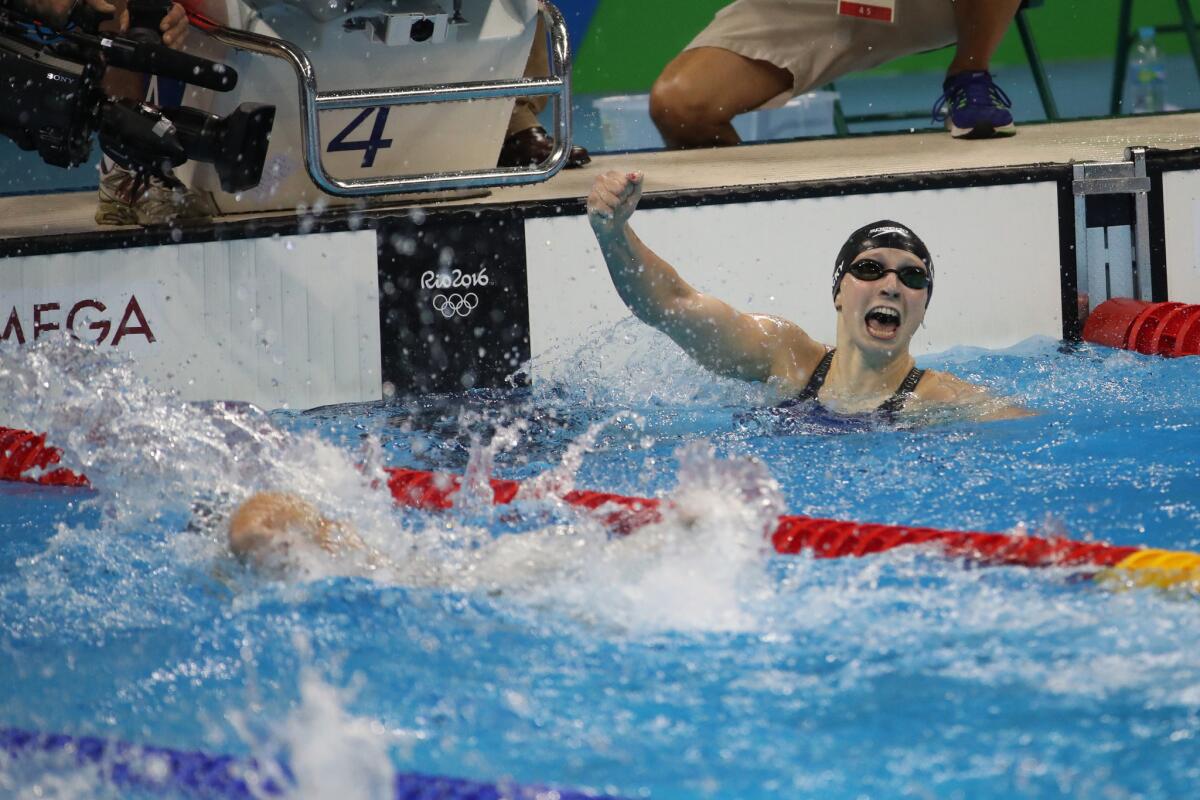 While other competitors are still swimming to the finish, Katie Ledecky of the U.S. is already celebrating after winning the women's 400-meter freestyle in world-reocrd time at the Olympic Aquatics Stadium in Rio de Janeiro.