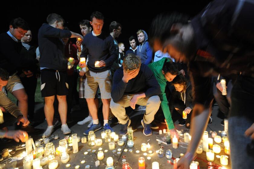 Mourners gather Wednesday during a memorial for those who were killed after a balcony gave way in Berkeley the night before.