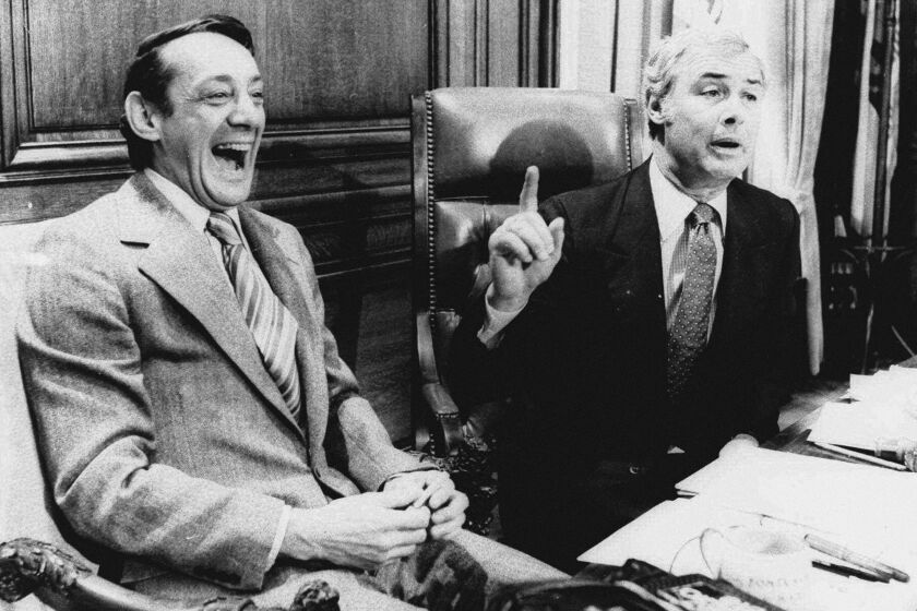 FILE - In this April 1977 file photo, San Francisco Supervisor Harvey Milk, left, and Mayor George Moscone sit together in the mayor's office during the signing of the city's gay rights bill. (AP Photo/File)