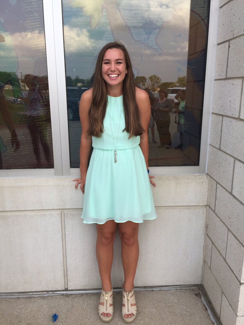 Mollie Tibbetts, in her Homecoming dress, smiles for the camera.