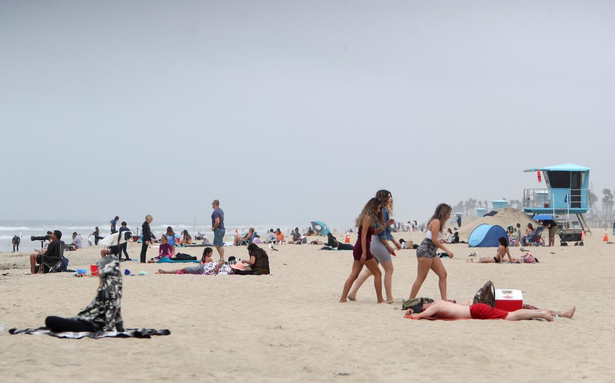 Light crowds were on the sand at Huntington City Beach, in Huntington Beach on Thursday. California Gov. Gavin Newsom said all state and local beaches in Orange County must close.