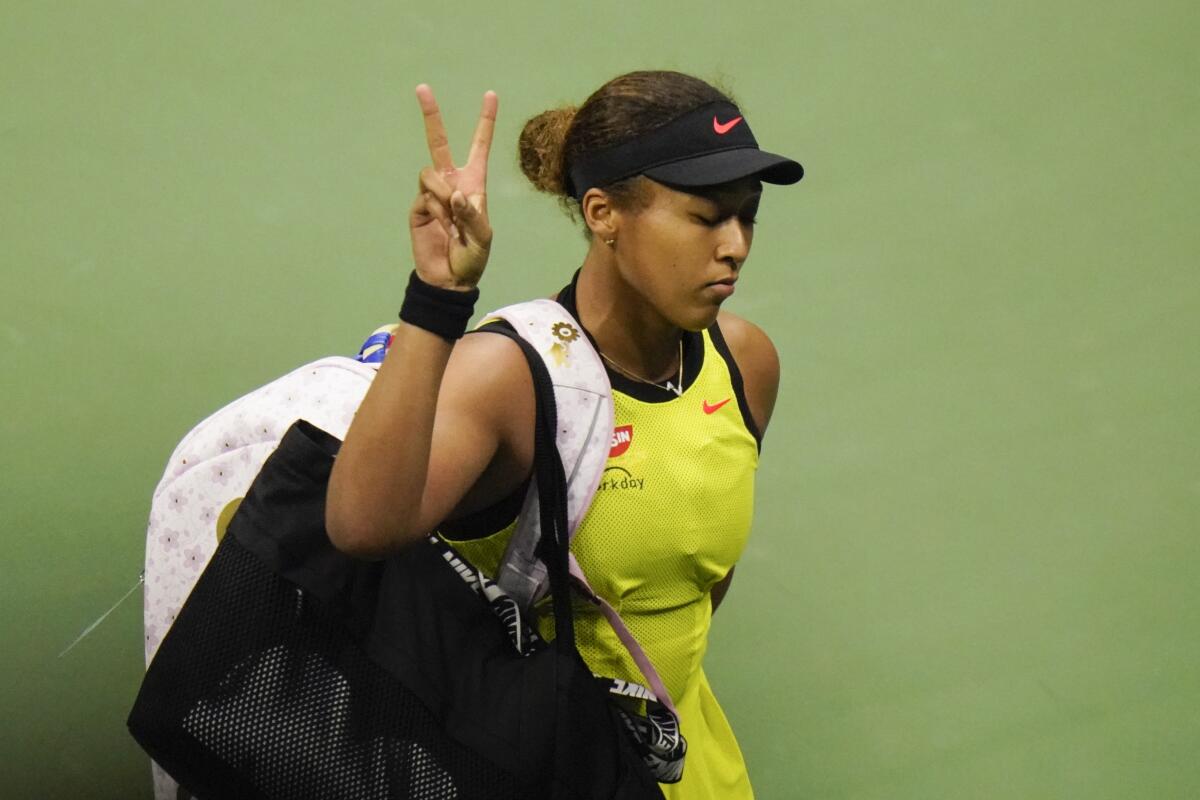 Naomi Osaka flashes a peace gesture to fans after losing to Leylah Fernandez at the U.S. Open on Friday.