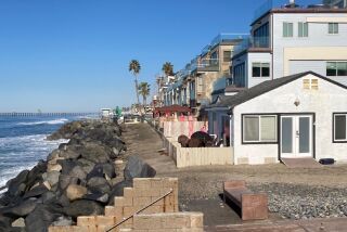 Condos protected by rock revetments line the beach north of bungalows to replaced by a 3-story vacation rental structure.