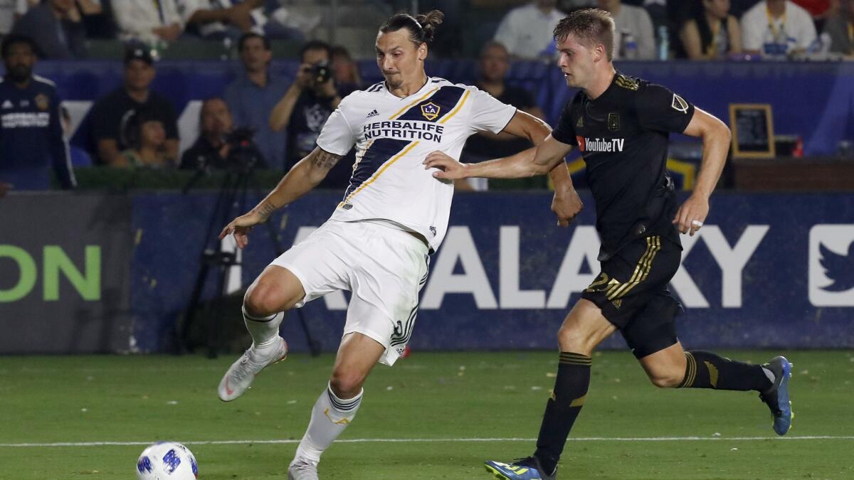 Galaxy forward Zlatan Ibrahimovic tries to get the ball inside against LAFC defender Walker Zimmerman.