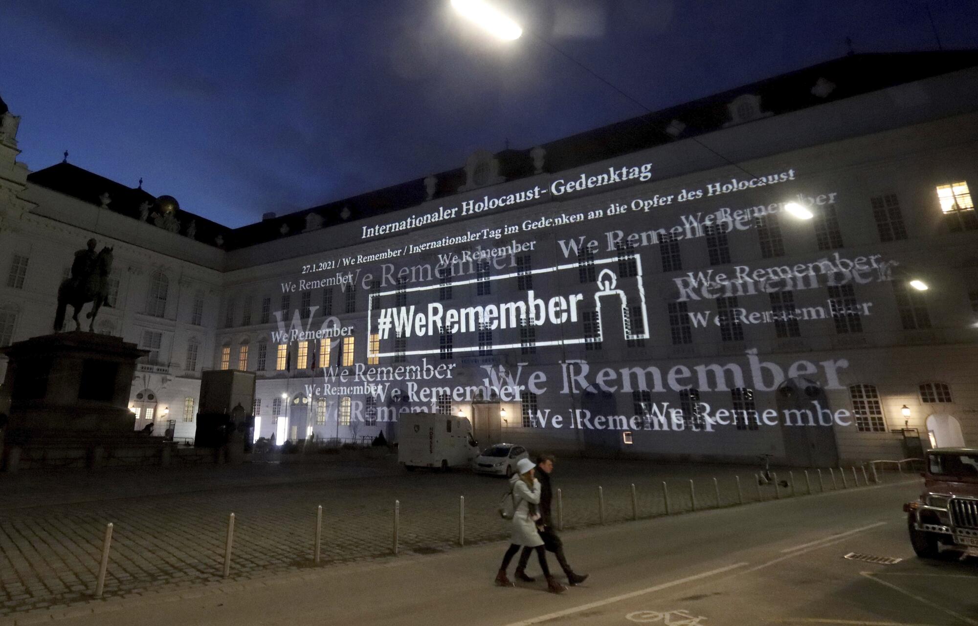 The words '#WeRemember' are displayed at the facade of the Austrian Parliament at the Hofburg 