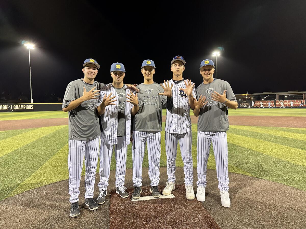 Five Sherman Oaks Notre Dame pitchers smile on the field.