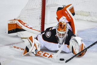 Anaheim Ducks goalie Lukas Dostal dives for the puck during third-period NHL hockey game action.