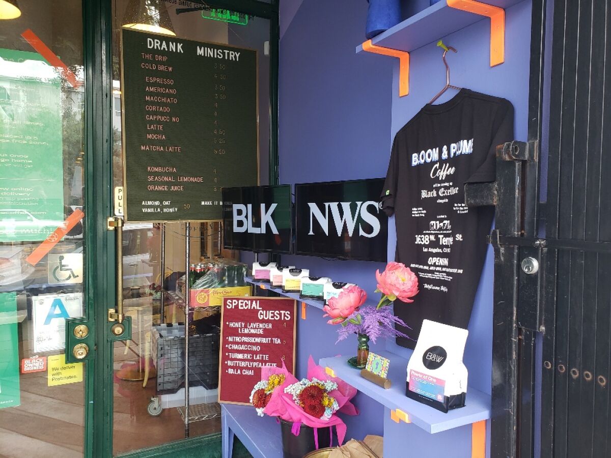 Kahlil Joseph's "BLKNWS®" plays on a pair of screens at Bloom & Plume coffee shop in Historic Filipinotown.