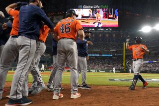 Houston Astros' Jose Altuve (27) celebrates with teammates after hitting a three-run home run against the Texas Rangers during the ninth inning in Game 5 of the baseball American League Championship Series Friday, Oct. 20, 2023, in Arlington, Texas. (AP Photo/Julio Cortez)