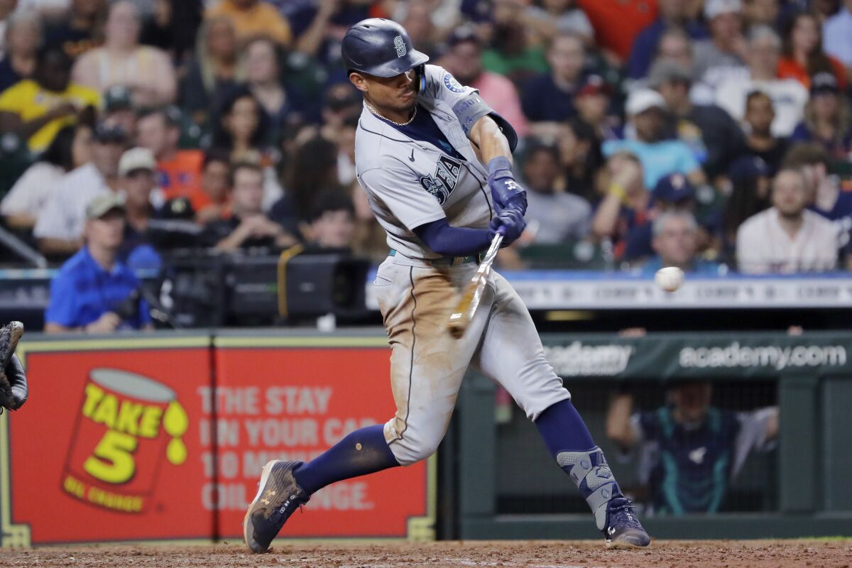 Seattle Mariners' Julio Rodriguez hits an RBI double against the Houston Astros during the eighth inning of a baseball game Friday, July 29, 2022, in Houston. (AP Photo/Michael Wyke)