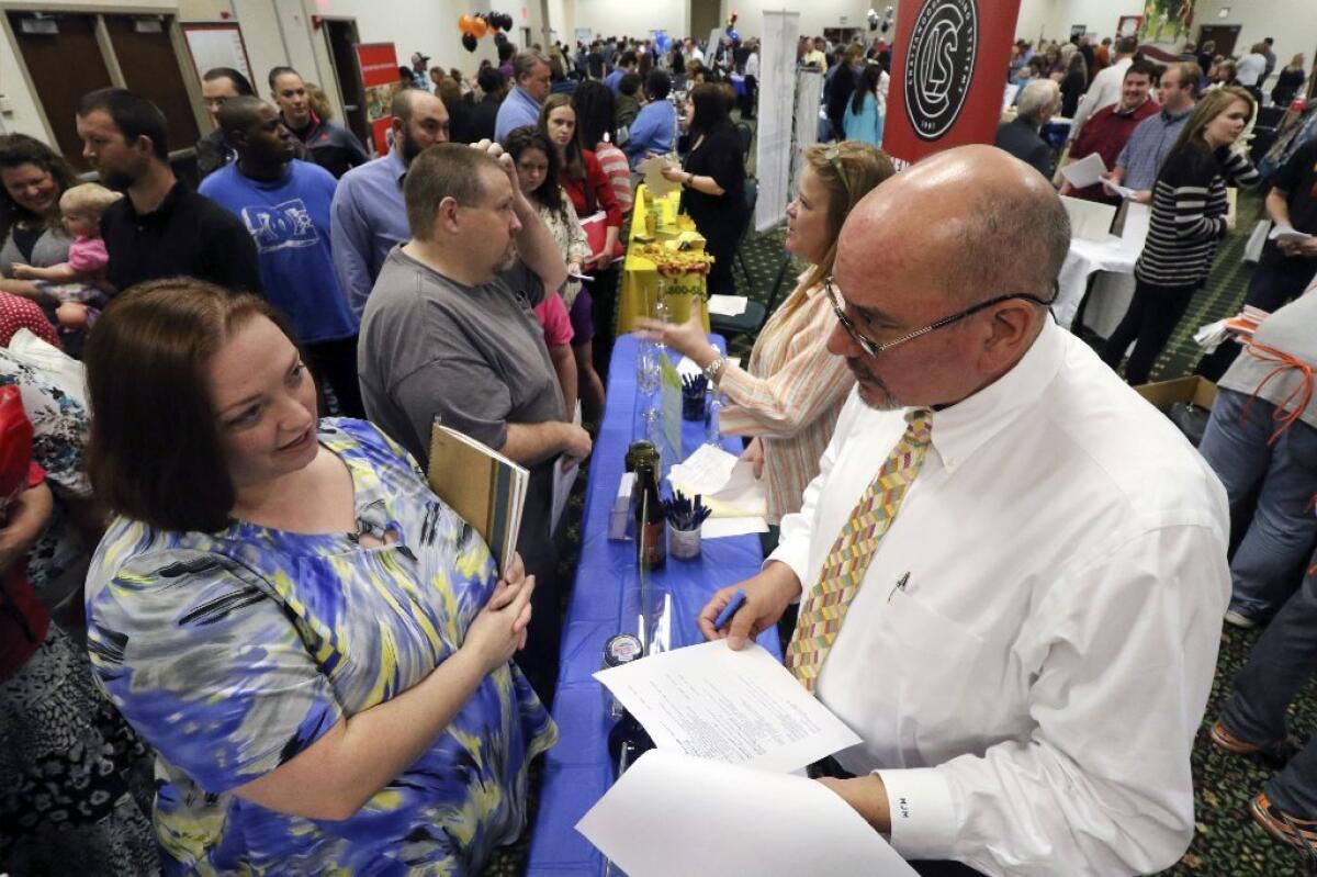 People attend a job fair at a civic center in Ringgold, Ga.