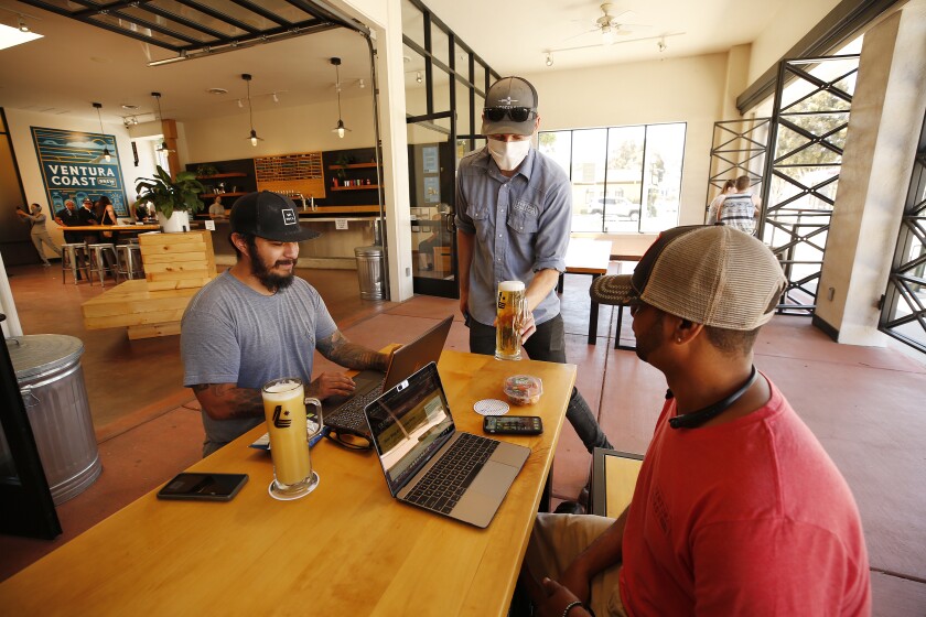 Customers enjoy outdoor seating at the Fire Up Bar & Grill in downtown Riverside 