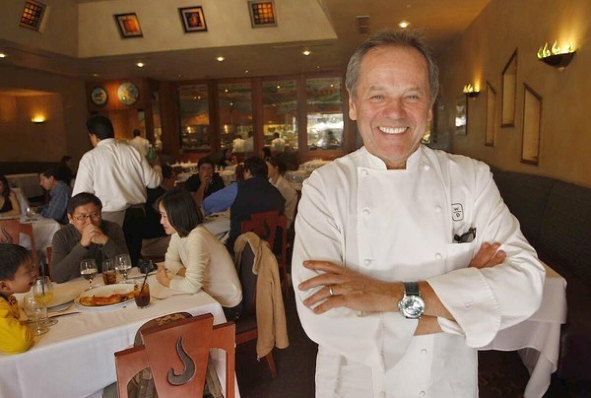 Wolfgang Puck in his Spago restaurant in Beverly Hills. He keeps a grueling schedule, traveling about 180 days a year.