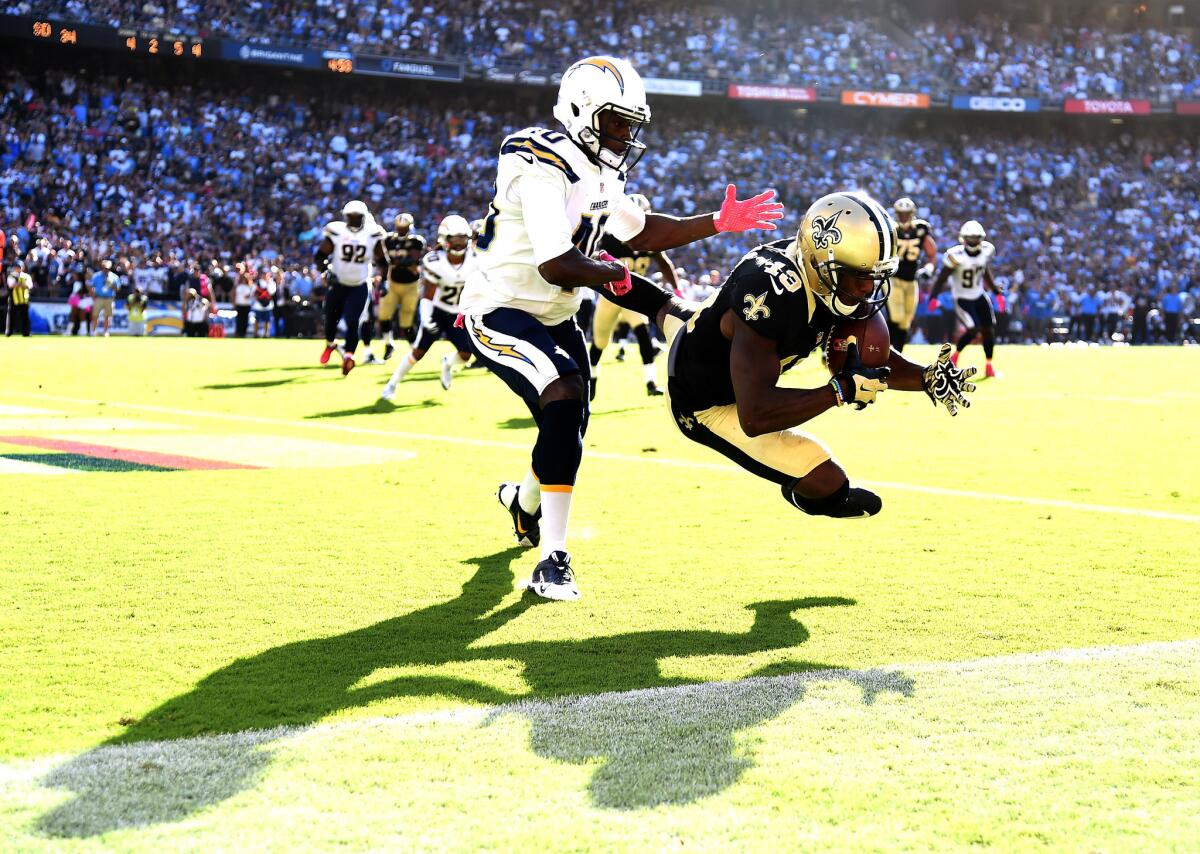 Saints receiver Michael Thomas (13) makes a catch for a touchdown in front of Chargers defensive back Pierre Desir (40) late in the fourth quarter.