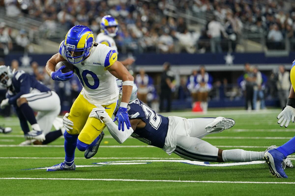 Cooper Kupp (10) is tackled by Dallas Cowboys cornerback DaRon Bland after the Rams receiver made a catch. 
