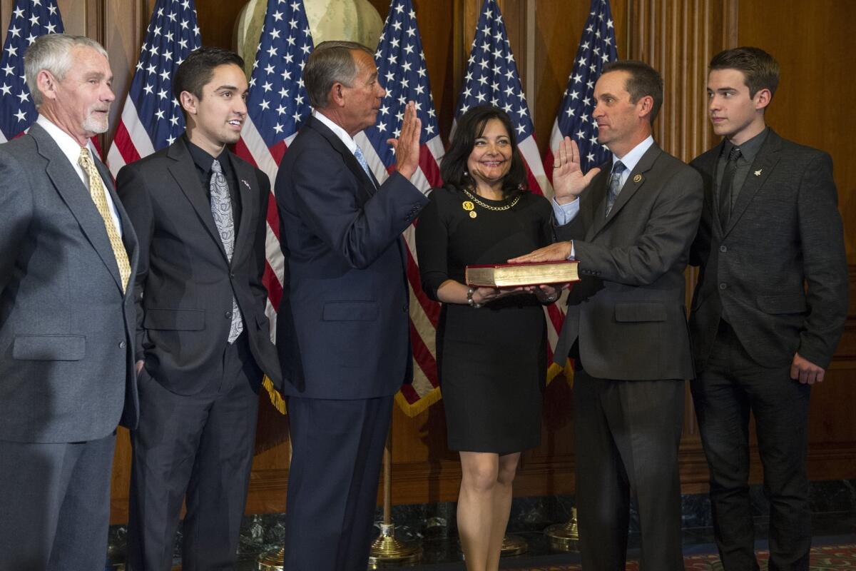House Speaker John Boehner of Ohio administers a ceremonial re-enactment of the House oath-of-office to Rep. Steve Knight (R-Calif.). A special election was called to fill Knight's state Senate seat.