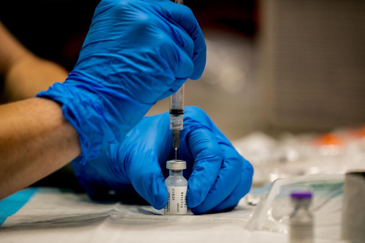 A nurse fills a syringe with the Pfizer Covid-19 vaccine.